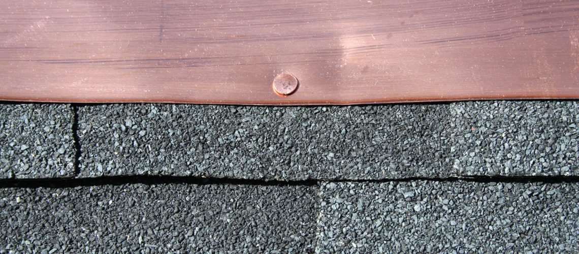 Black asphalt roofing shingles with copper flashing