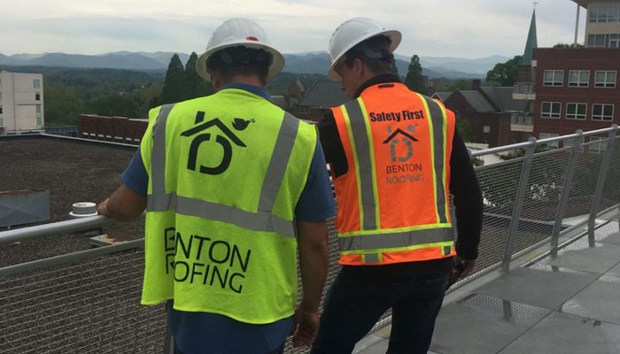 Commercial roofer in a safety vest